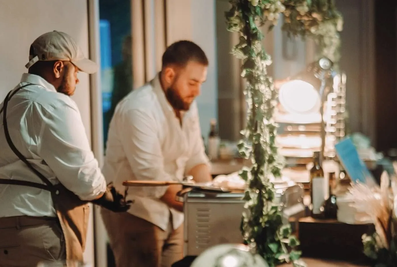 Two chefs plating at an event